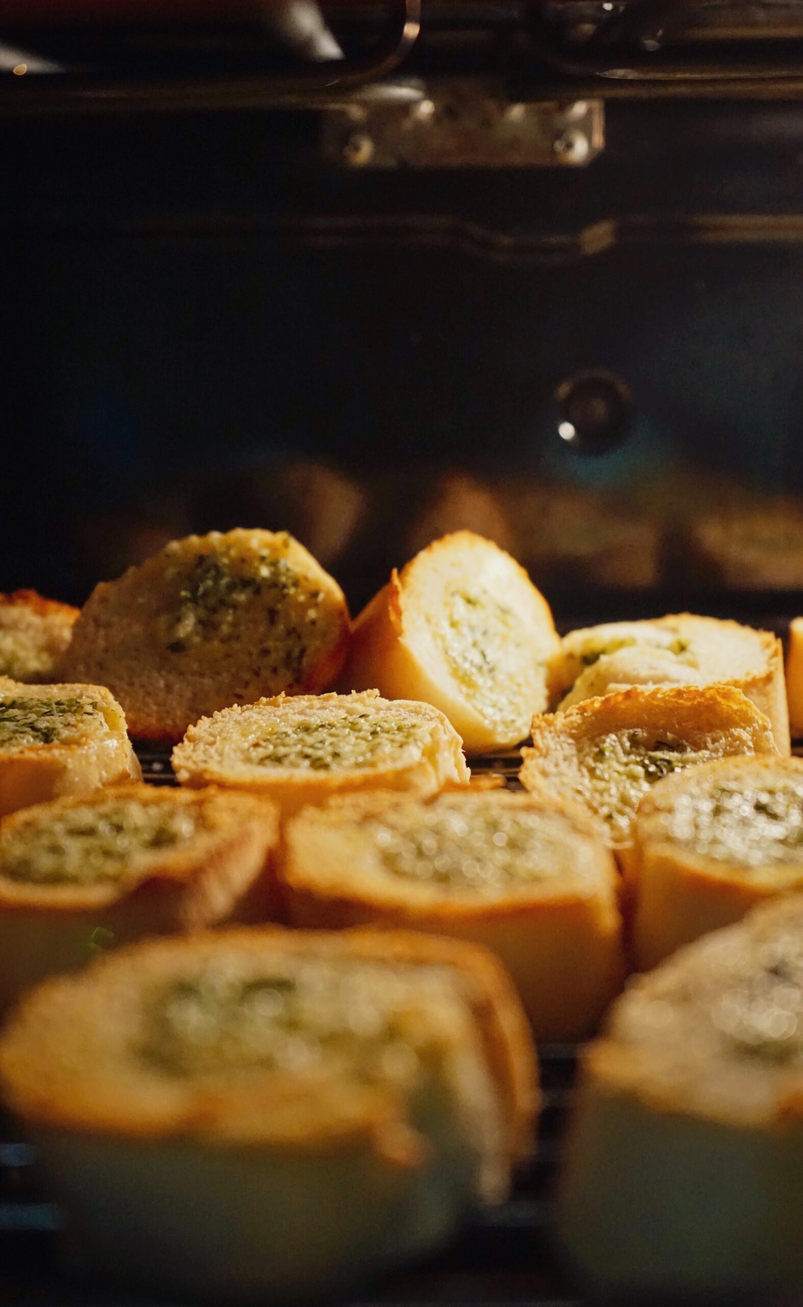 Sliced french garlic bread in an oven