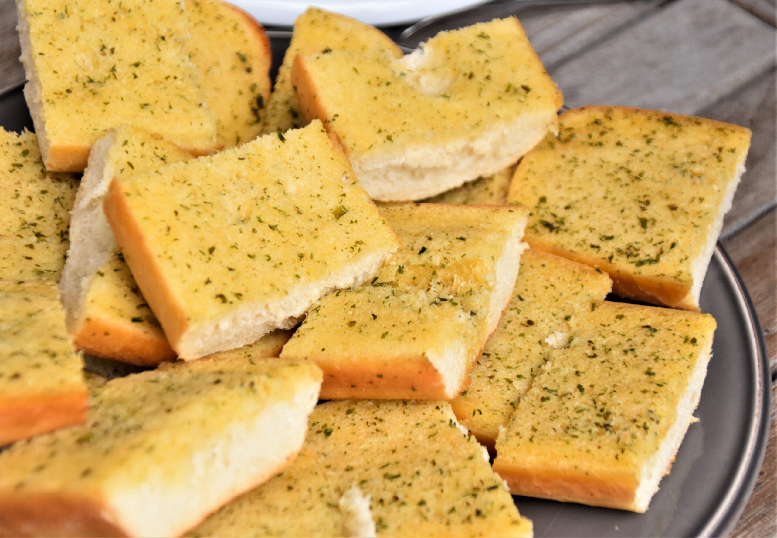 Plate of sliced garlic bread with parsley